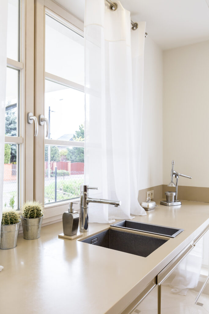 Kitchen worktop with minimalistic, silver amenities and grey stone sinks and a vinyl windows summerville sc