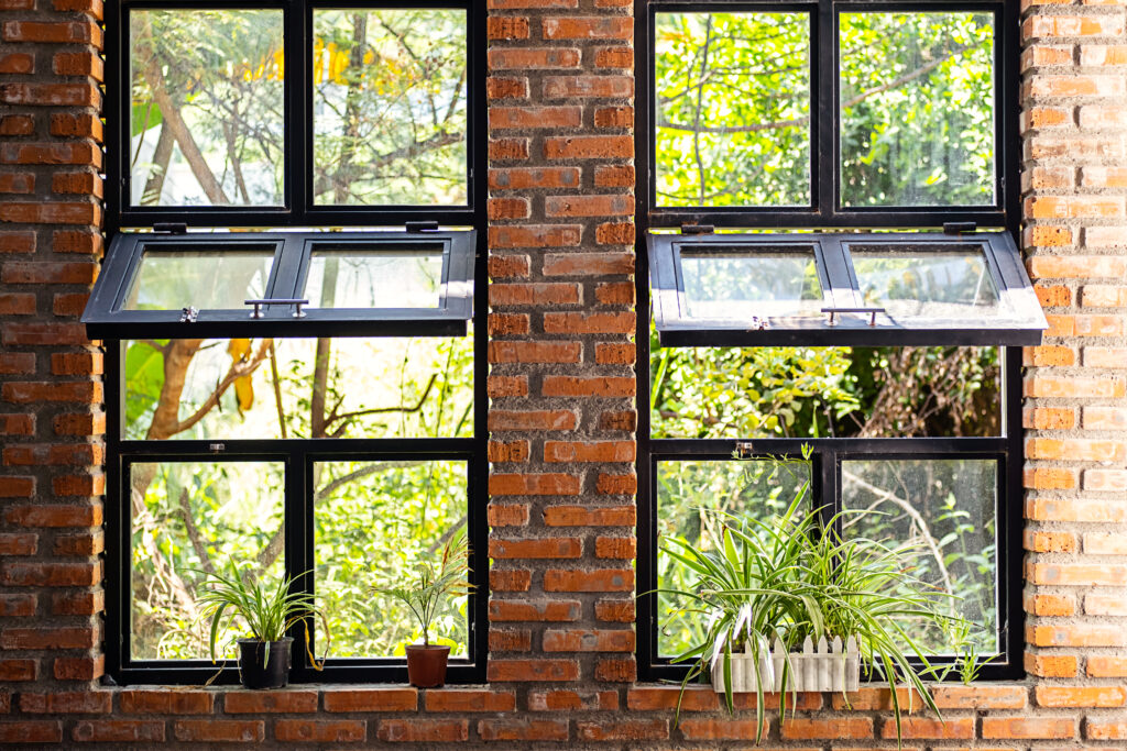Modern workshop with big awning windows summerville sc and indoor garden. Landscaped coworking space.