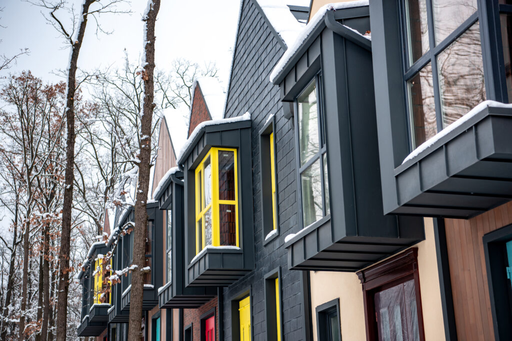 stylish modern buildings with snow on roofs in winter